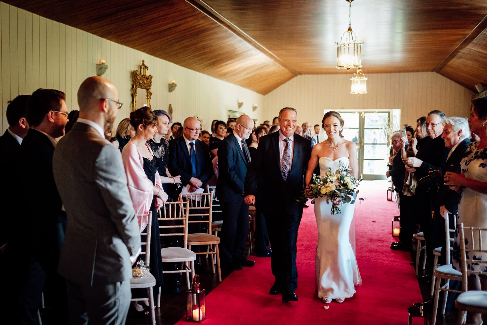 bride walks down the aisle with her father at a Clonabreany house wedding