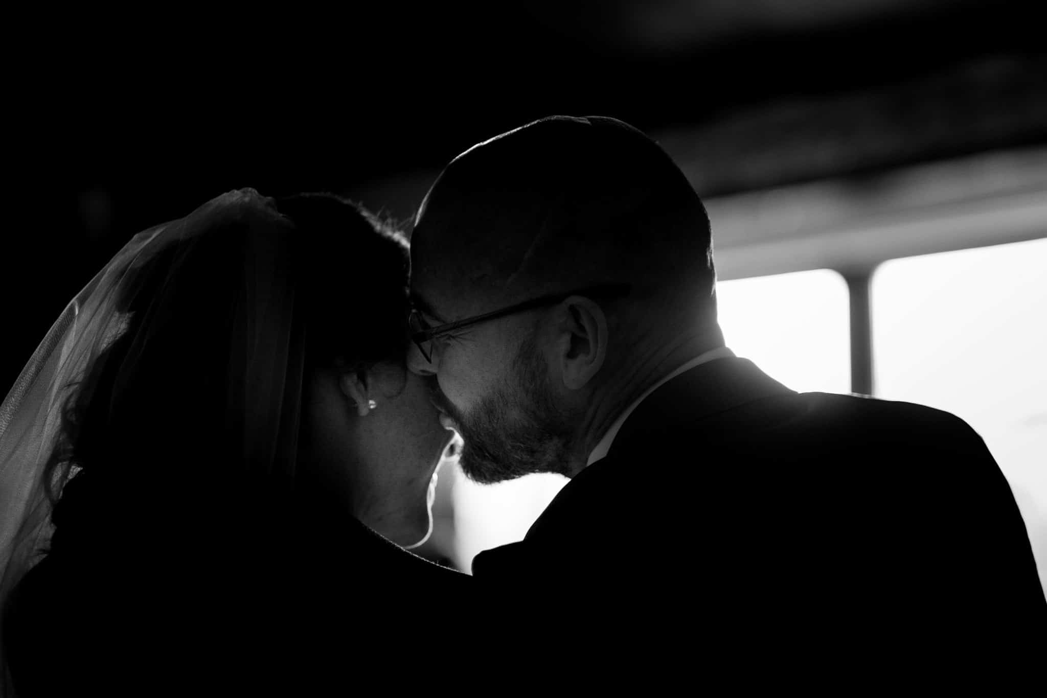 groom kisses his bride on the cheek