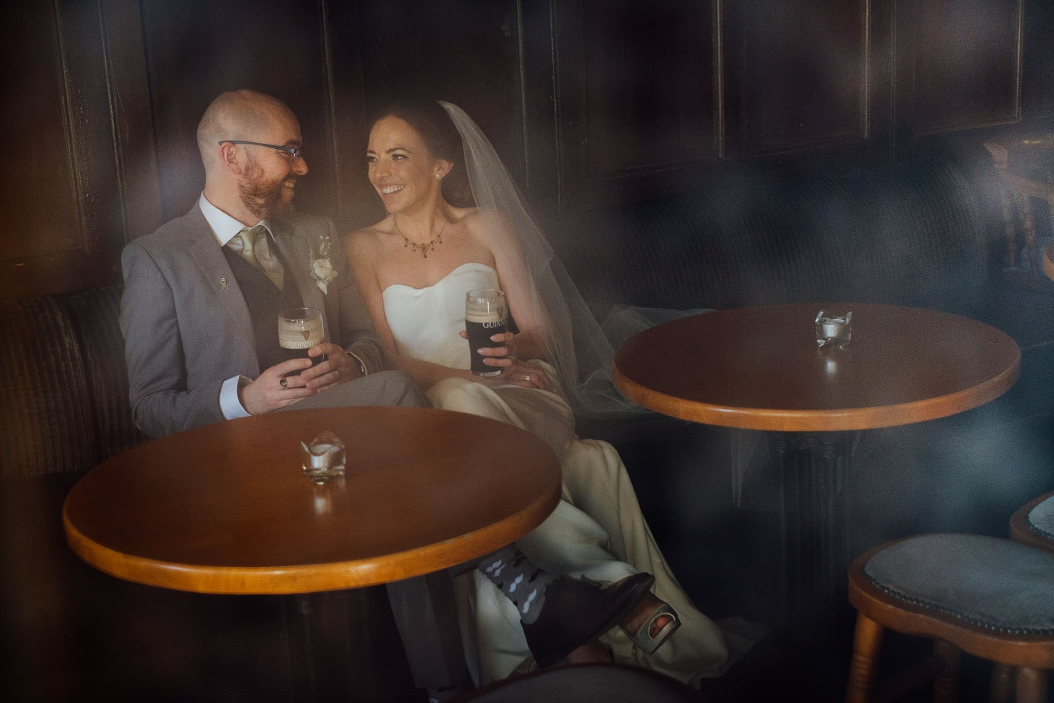 bride and groom drink a pint of guinness