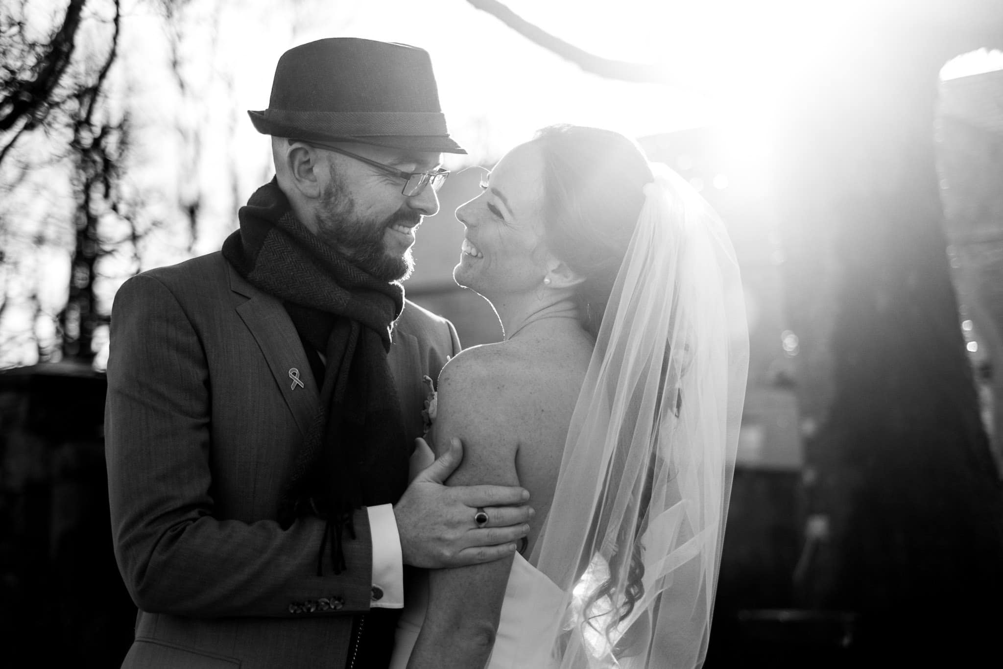 bride and groom smiling in the sun