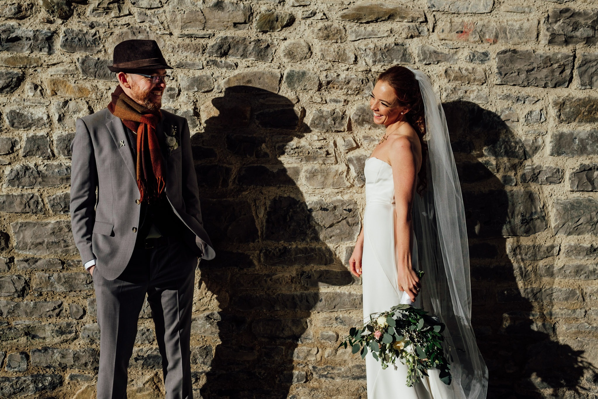 bride and groom smiling at each other in the sun