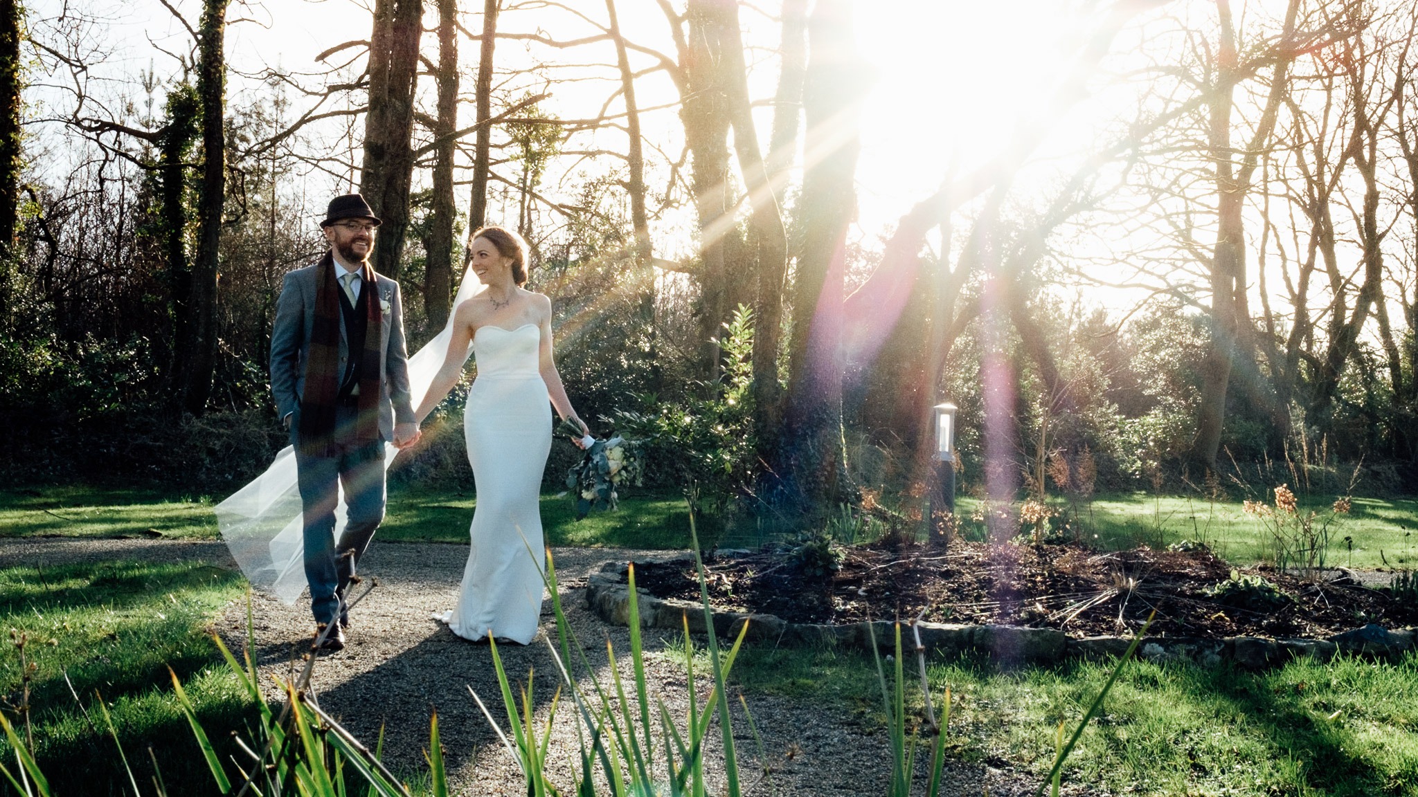 bride and groom walking around the grounds of clonabreany house