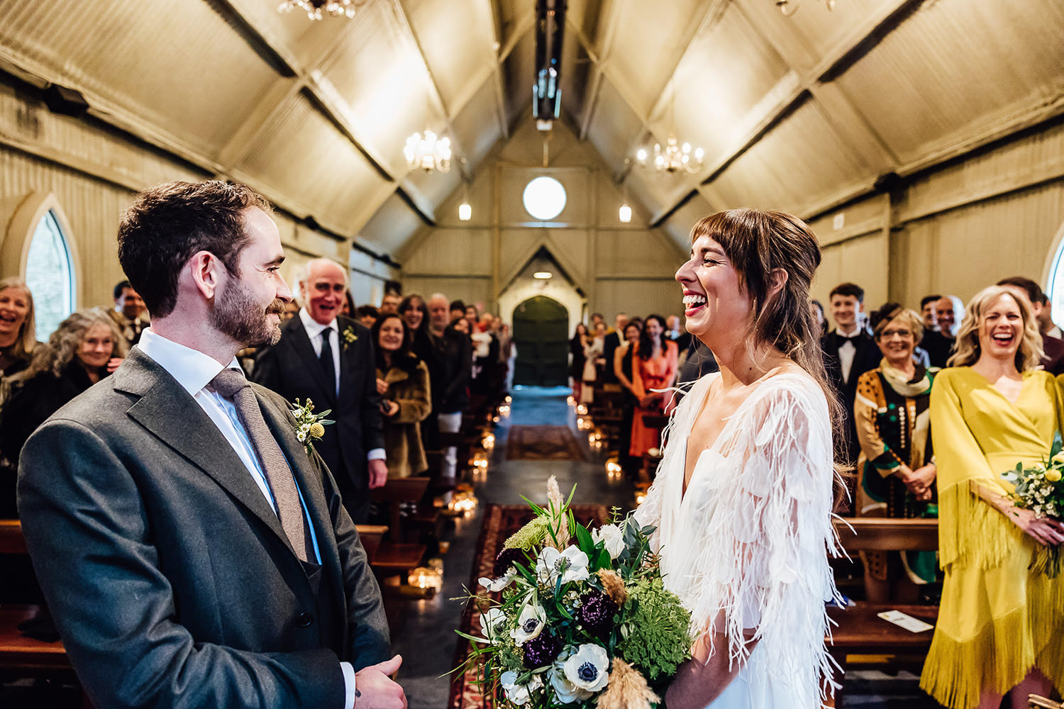A bride and groom laughing during their wedding ceremony at Mount Druid