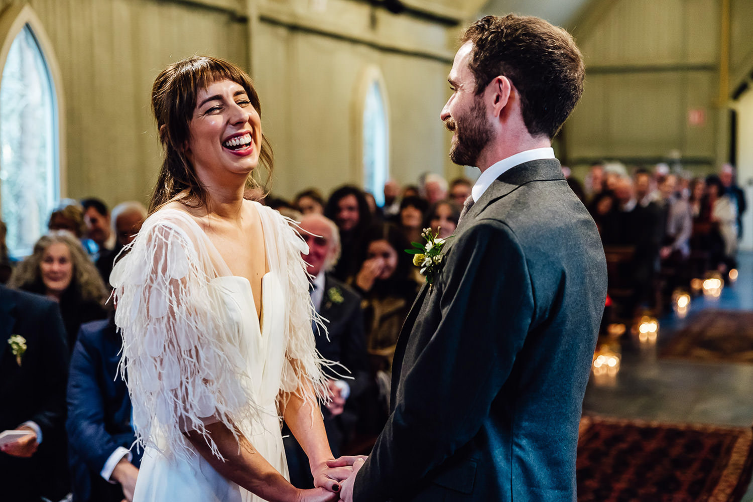 A bride and groom laughing during their wedding ceremony at Mount Druid