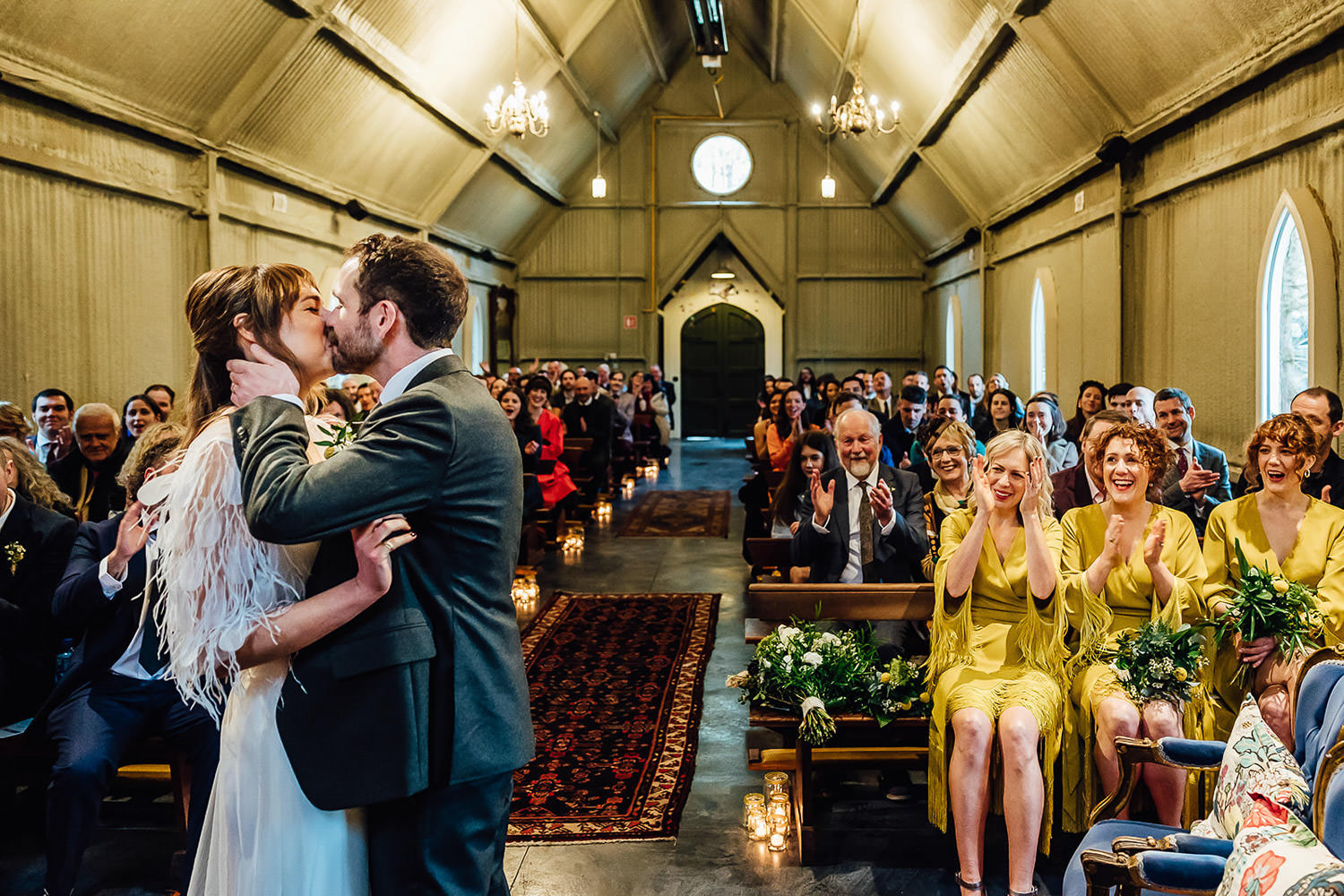 A bride and groom kiss during their wedding ceremony at Mount Druid