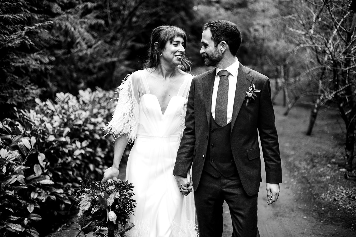 A bridal and groom embrace pose after the ceremony at a tin church at Mount Druid